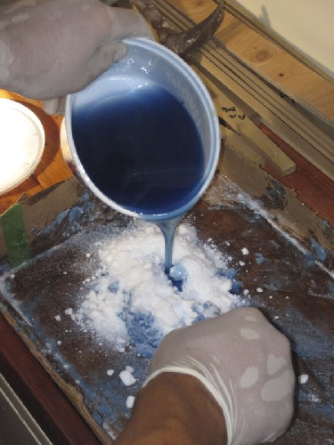 Bill the fibreglass expert mixing up some putty to prep the bilge corners for easy glassing