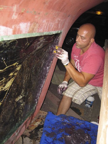 Bill the fiberglass expert packing some Polybond putty into the keel wound