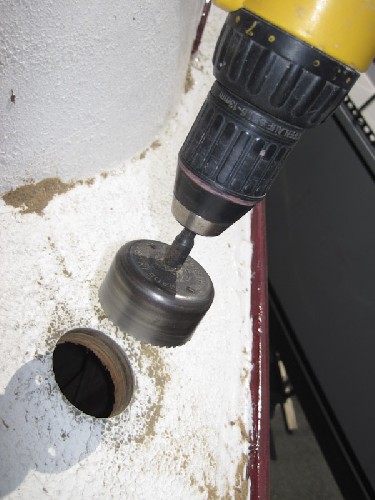 Drilling yet another gaping hole in the deck, this time for a toilet holding tank port.