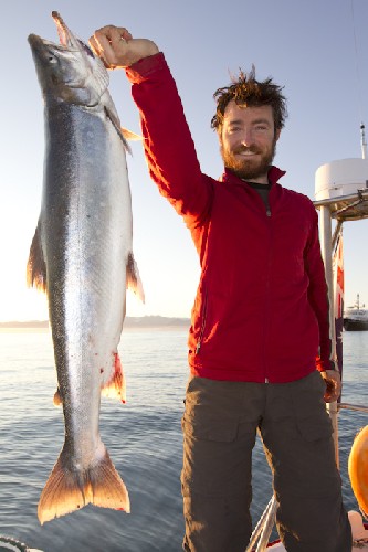 Chris holding up a giant Arctic Char for dinner