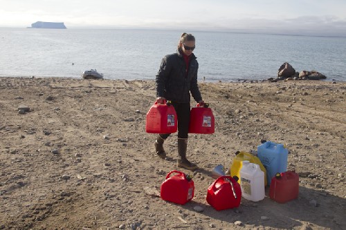 Jess bringing ashore jerry cans to fill with diesel