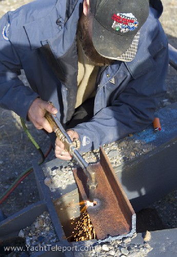Phil blowing holes in the steel with his oxy torch, for the yacht trailer