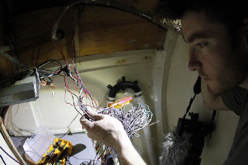 Chris trying to untangle and understand the wiring inside the heads