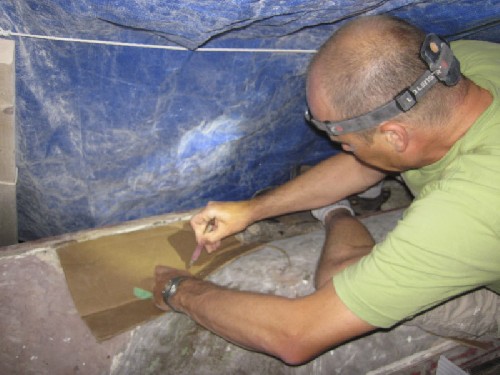 Dr Jim drawing a template for the shape of wood needed to replace the rotten area