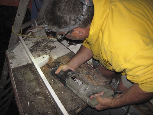 Terry cutting the cockpit side-wall off to make it easier to extract bad wood and lay fibre glass