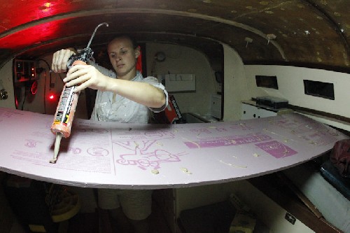 Messy Stuff - Jess squeezing some adhesive onto some insulating foam to stick on the roof