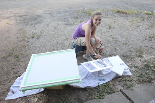 Jess painting the new saloon table, and galley cupboards etc