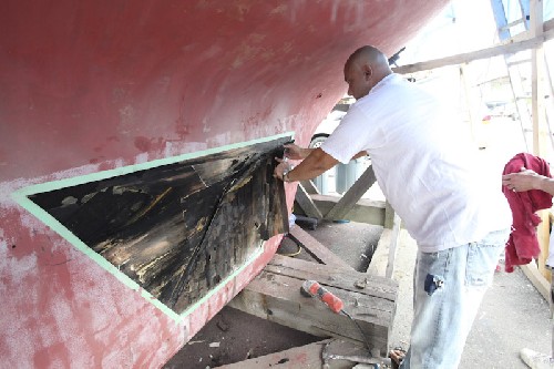 Yikes - revealing the damp wood behind the delaminated bulge in the keel - dry it out then we\'ll fix it