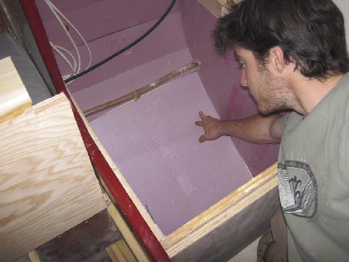 Insulating what used to be a mess of wires and switches and what will soon be a big ice box!